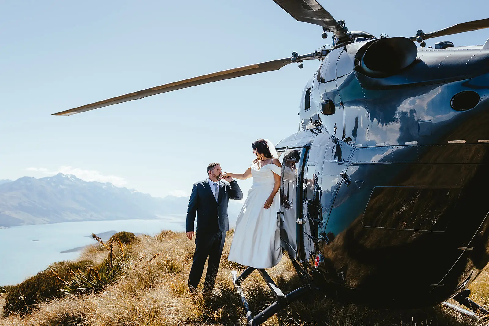 Freddie and Lene sharing a hand kiss above Lake Wakatipu at Mount Crichton