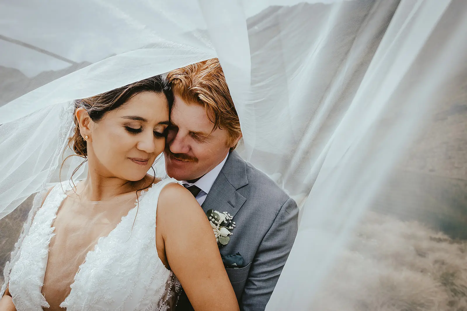 Tom and Lorena in an intimate veil portrait at Lake Alta near Wanaka