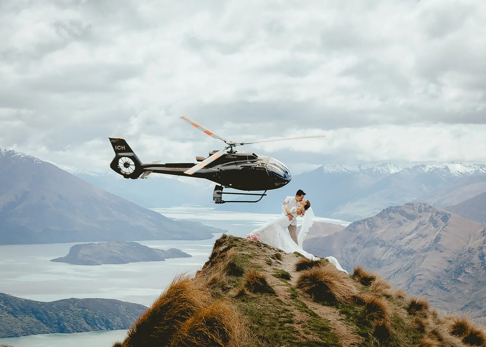 Joy and Hubert in an aerial dip kiss on the Coromandel Peak ridgeline above the lake