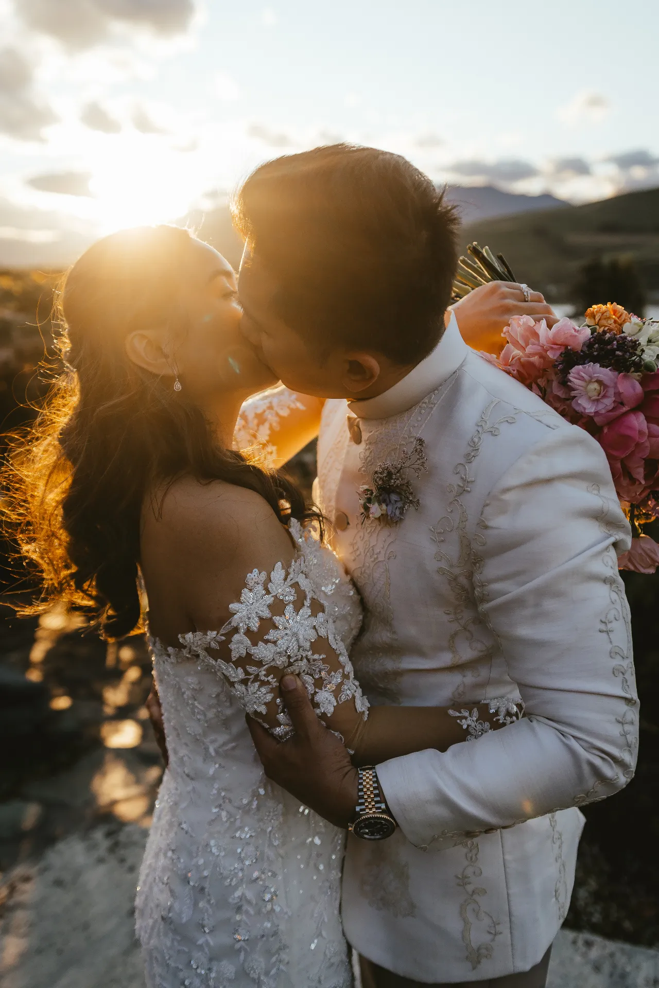 Couple embracing in golden evening light during a Queenstown elopement