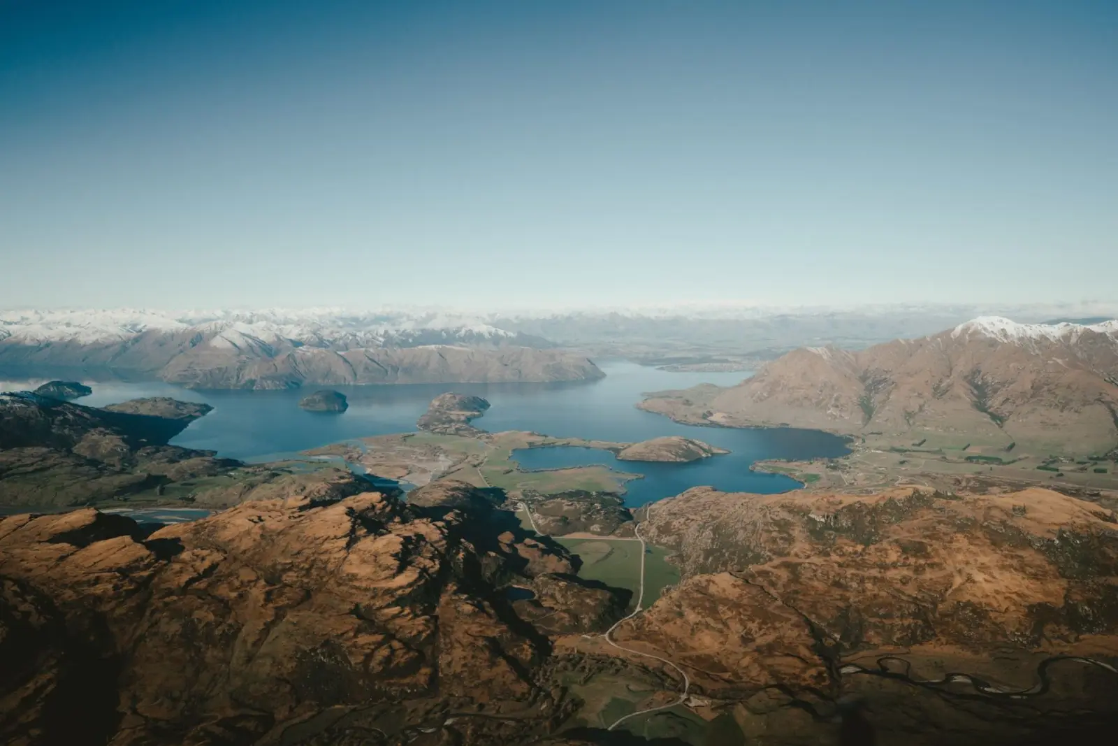 Aerial view from a helicopter over Lake Wanaka and snow-covered mountains