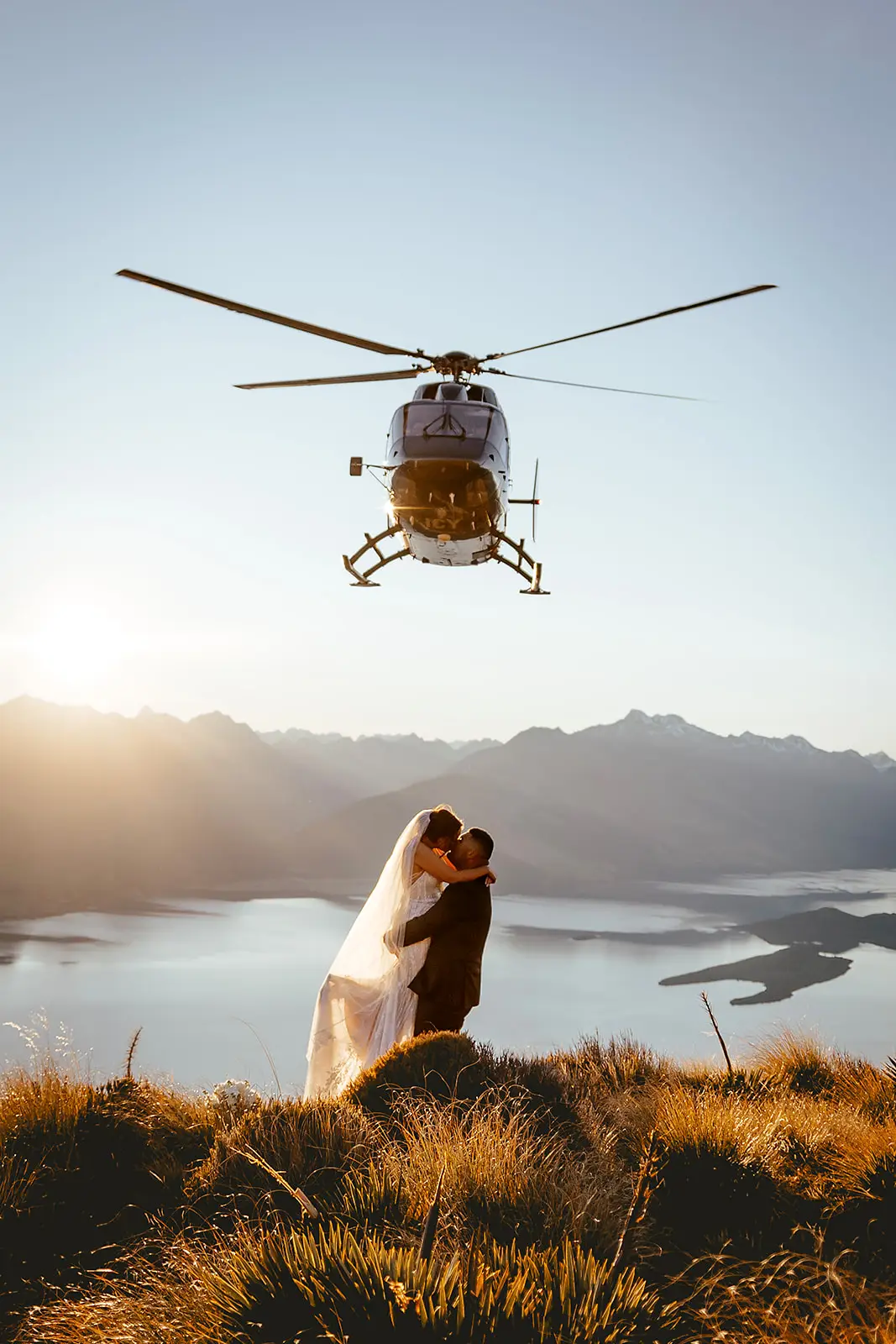 Triona and Edward mid-lift at sunset above Lake Wakatipu near Glenorchy