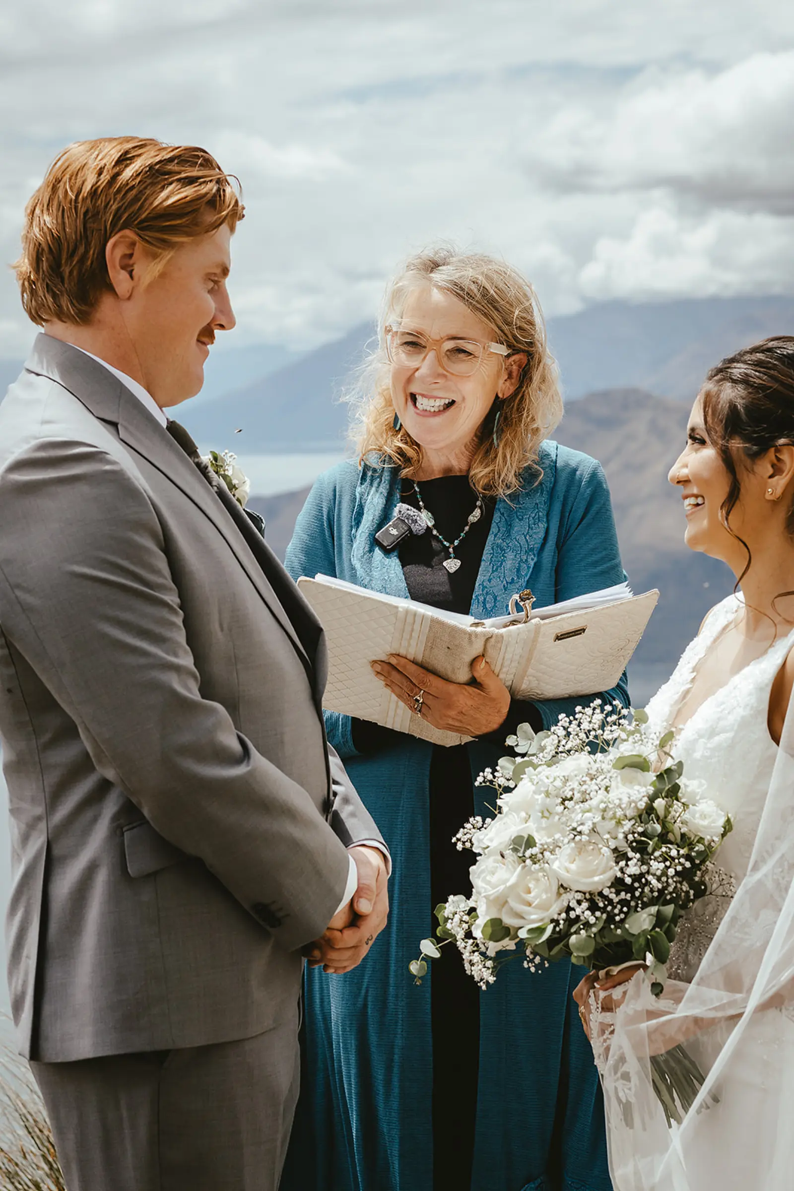 Celebrant reading vows with a couple on Coromandel Peak above Lake Wanaka